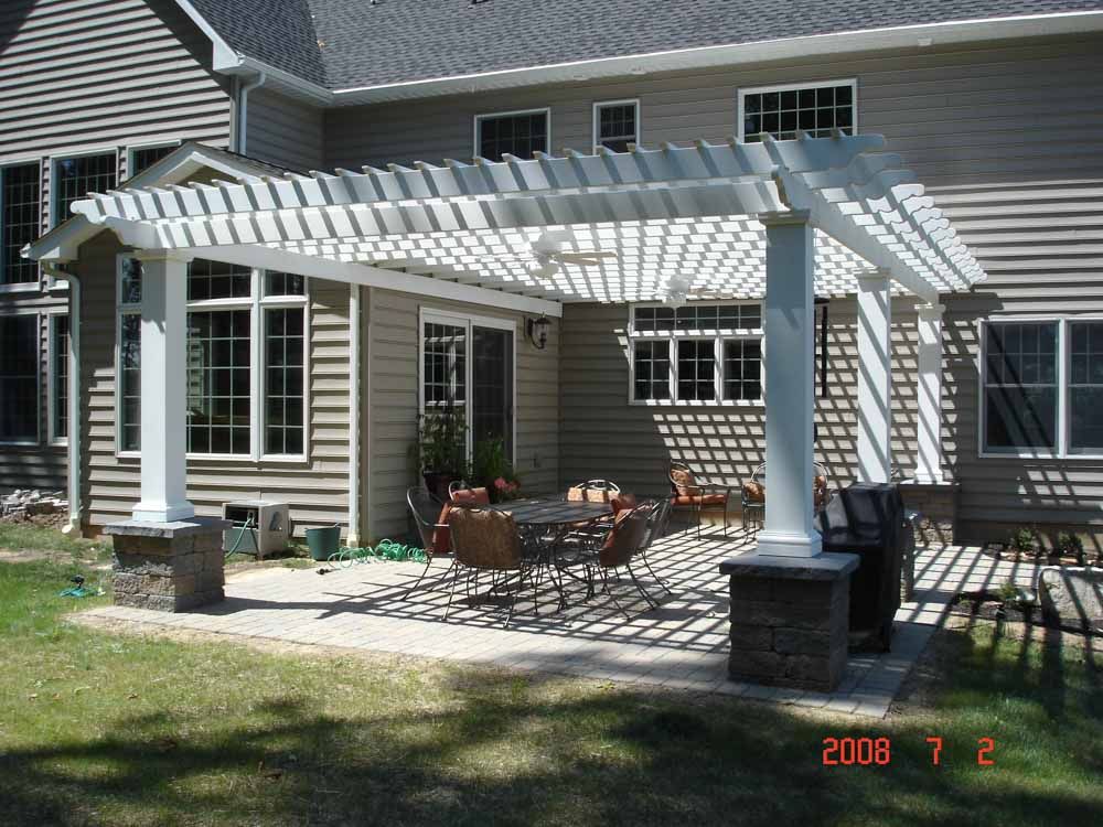A patio with a pergola and a table and chairs taken in 2008