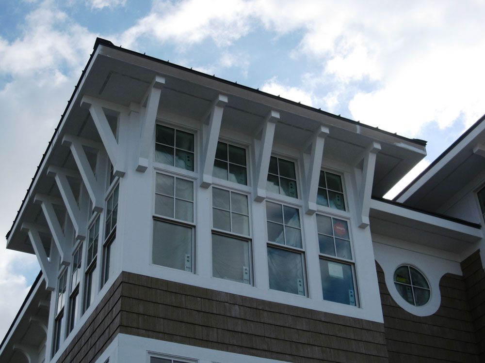A house with a lot of windows and a blue sky in the background