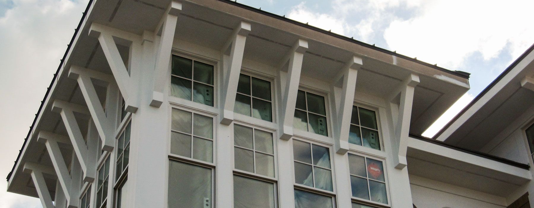 A white building with a lot of windows and a roof