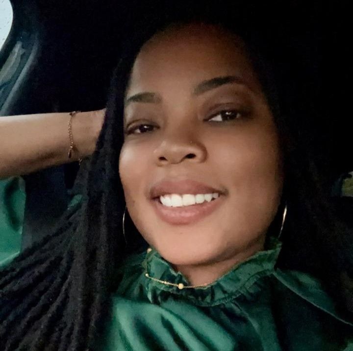 Un homme avec une barbe porte une chemise bleue et fait une drôle de grimace.