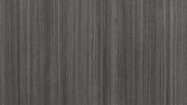 A close up of a gray wood grain texture.