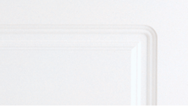 A close up of a white plate on a white surface.