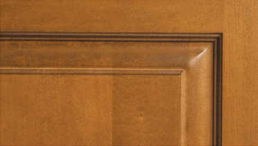 A close up of a wooden door with a black trim.