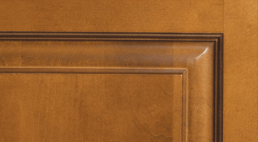 A close up of a wooden door with a brown trim.