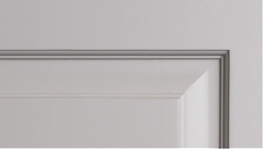 A close up of a white door with a gray trim.