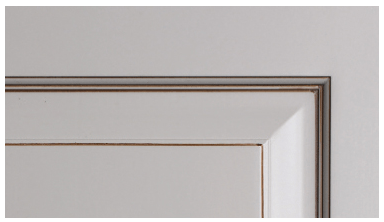 A close up of a white door with a silver trim