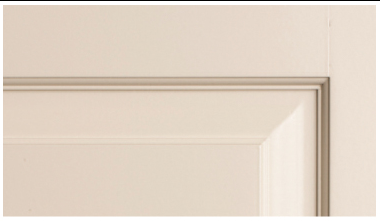 A close up of a white door with a molding on it.