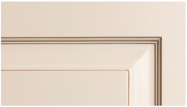 A close up of a white door with a brown trim