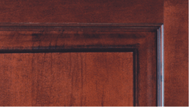 A close up of a wooden door with a black trim