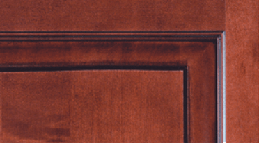 A close up of a wooden door with a black trim.