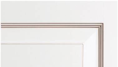 A close up of a white cabinet door with a brown trim.