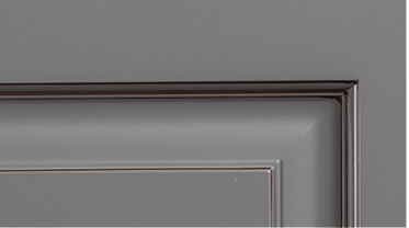 A close up of a gray door with a black trim.