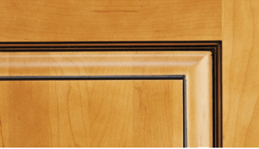 A close up of a wooden door with a black trim