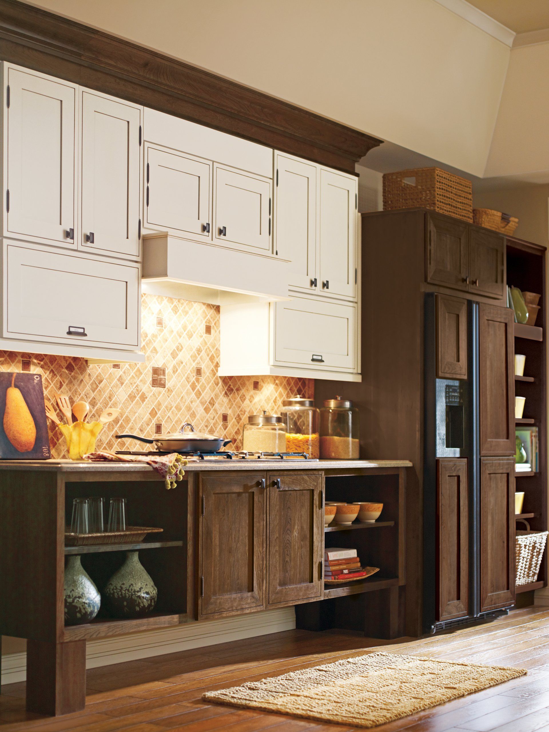 A kitchen with white cabinets and brown cabinets