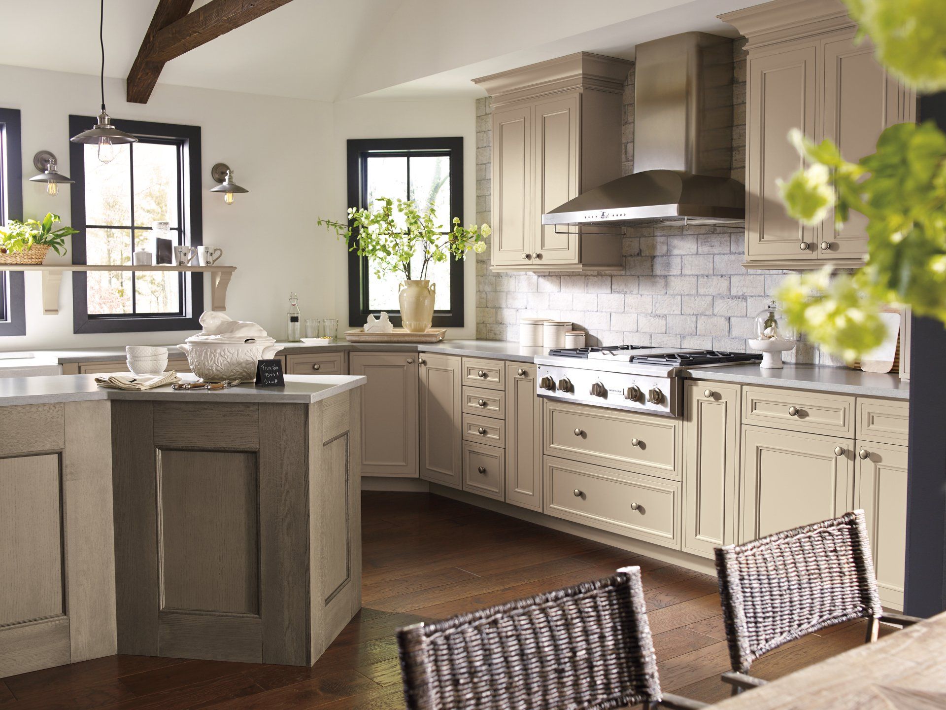 A kitchen with stainless steel appliances and wicker chairs