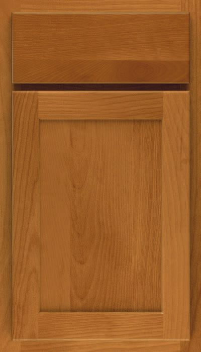 A close up of a wooden cabinet door with a black trim.