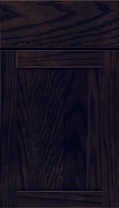 A close up of a black wooden cabinet door.