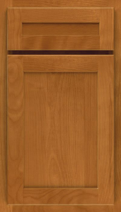 A close up of a wooden cabinet door with a black trim.