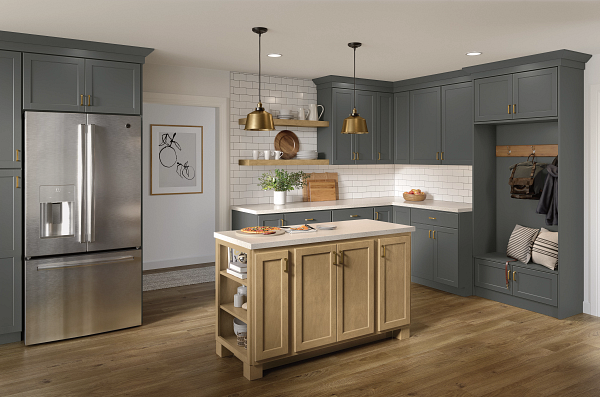 A kitchen with gray cabinets , stainless steel appliances , and a large island.