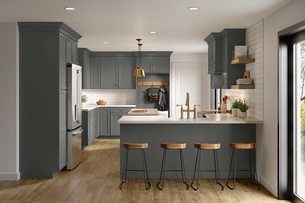 A kitchen with gray cabinets , stainless steel appliances , and a large island.