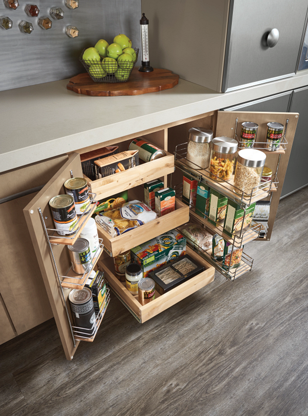 A kitchen pantry with drawers and shelves filled with food.