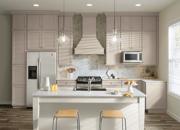 A kitchen with white cabinets , stainless steel appliances , a refrigerator and a stove.