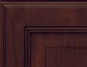 A close up of a dark wooden cabinet door.