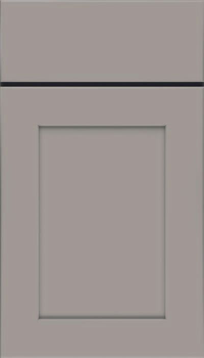 A close up of a light green cabinet door on a white background.