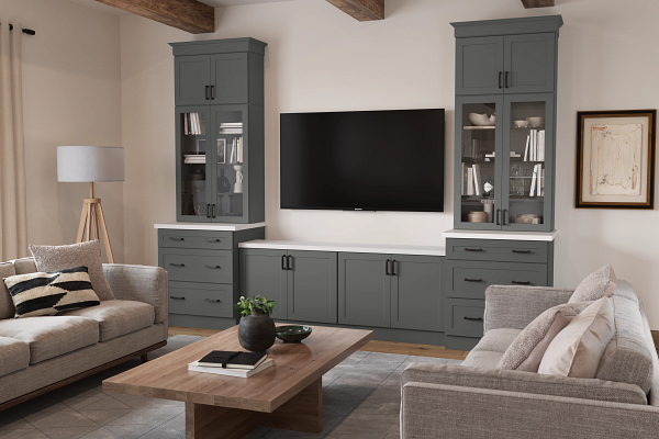 A living room with a couch , two chairs , a coffee table and a flat screen tv.