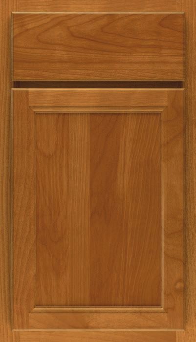A close up of a wooden cabinet door with a drawer.