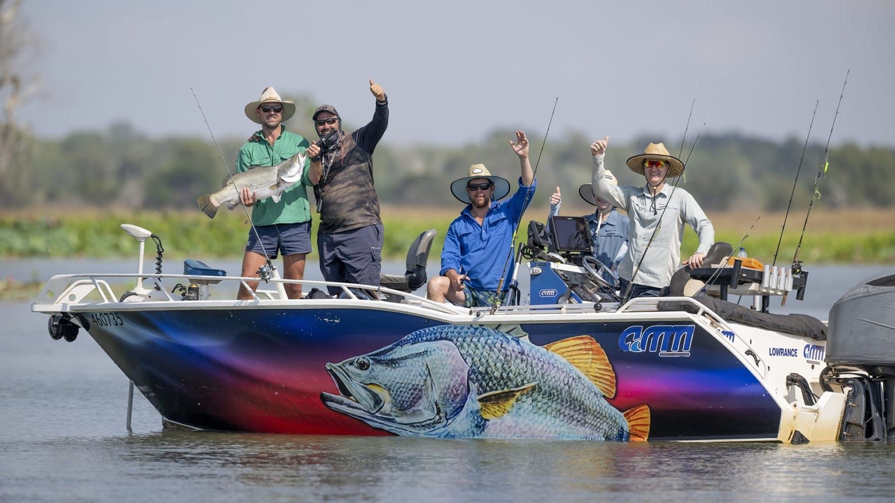 Group on Darwin fishing charter boat with barramundi catch