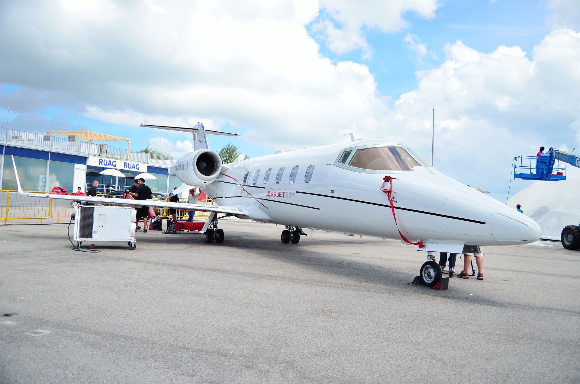 A white and red airplane is parked on a runway