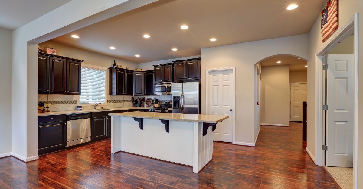 the kitchen is open to the living room and has a large island in the middle .