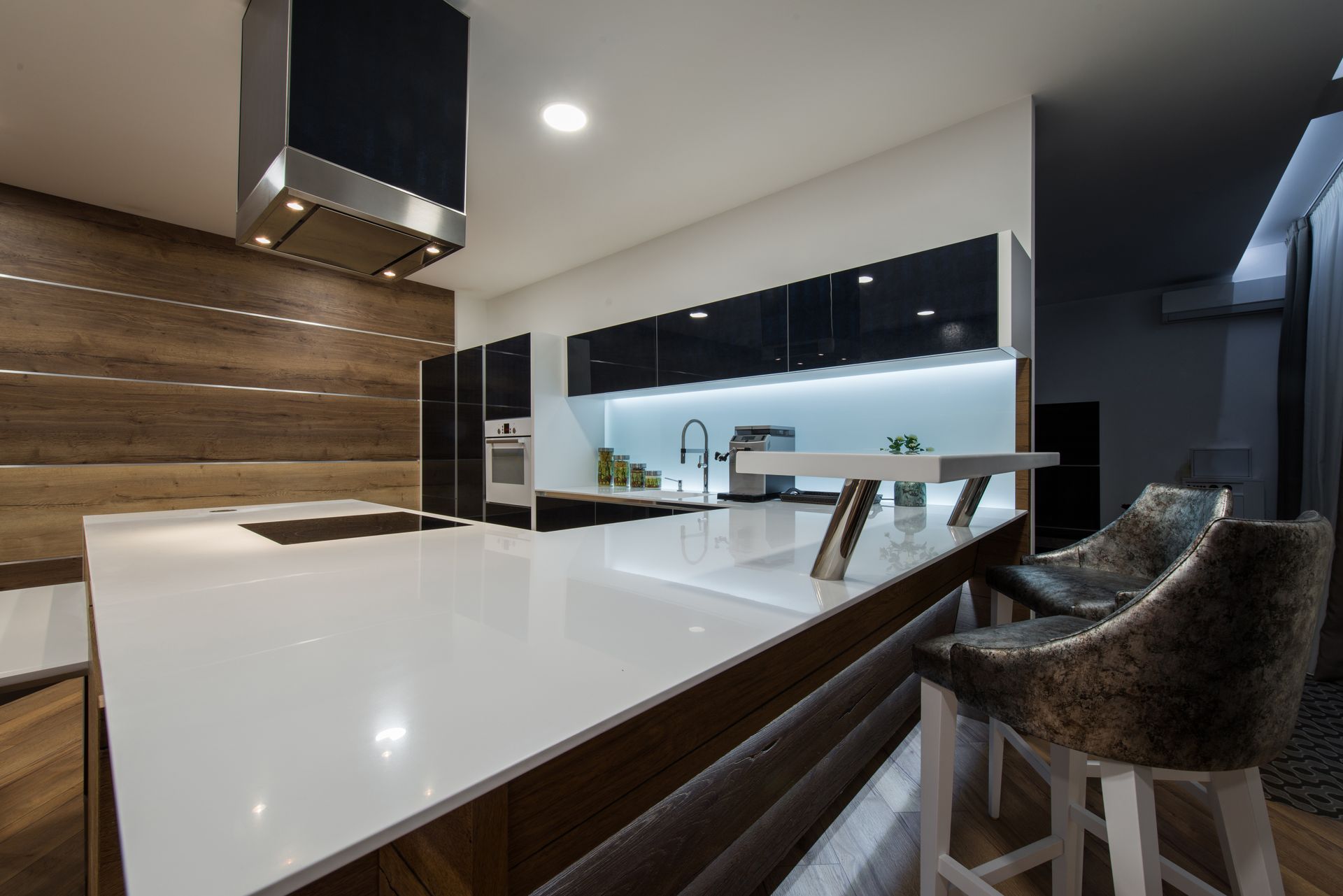 a modern kitchen with a large island and stools