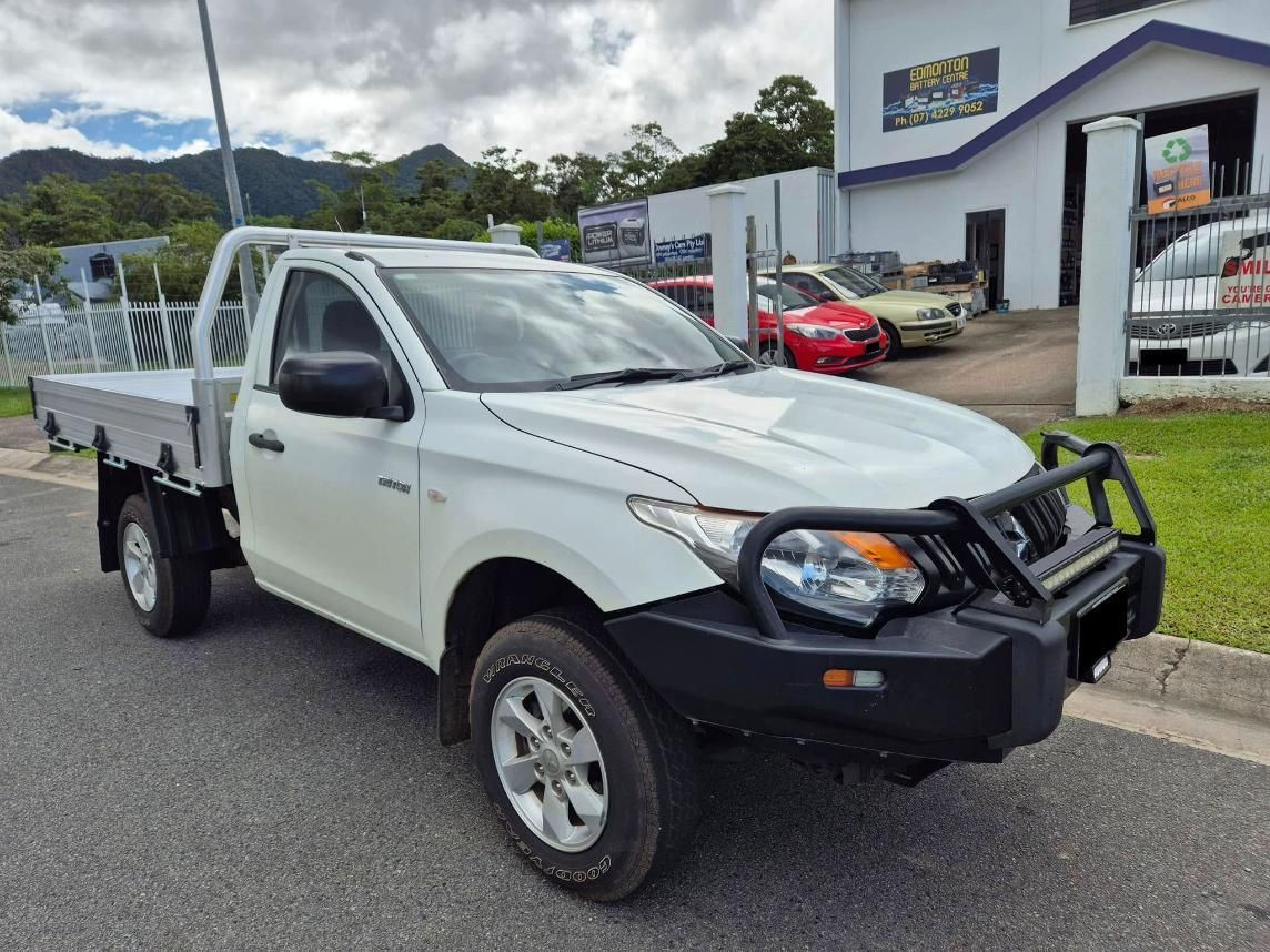 A White Truck Is Parked In Front Of A Building — Downsy's Cars In Bentley Park, QLD