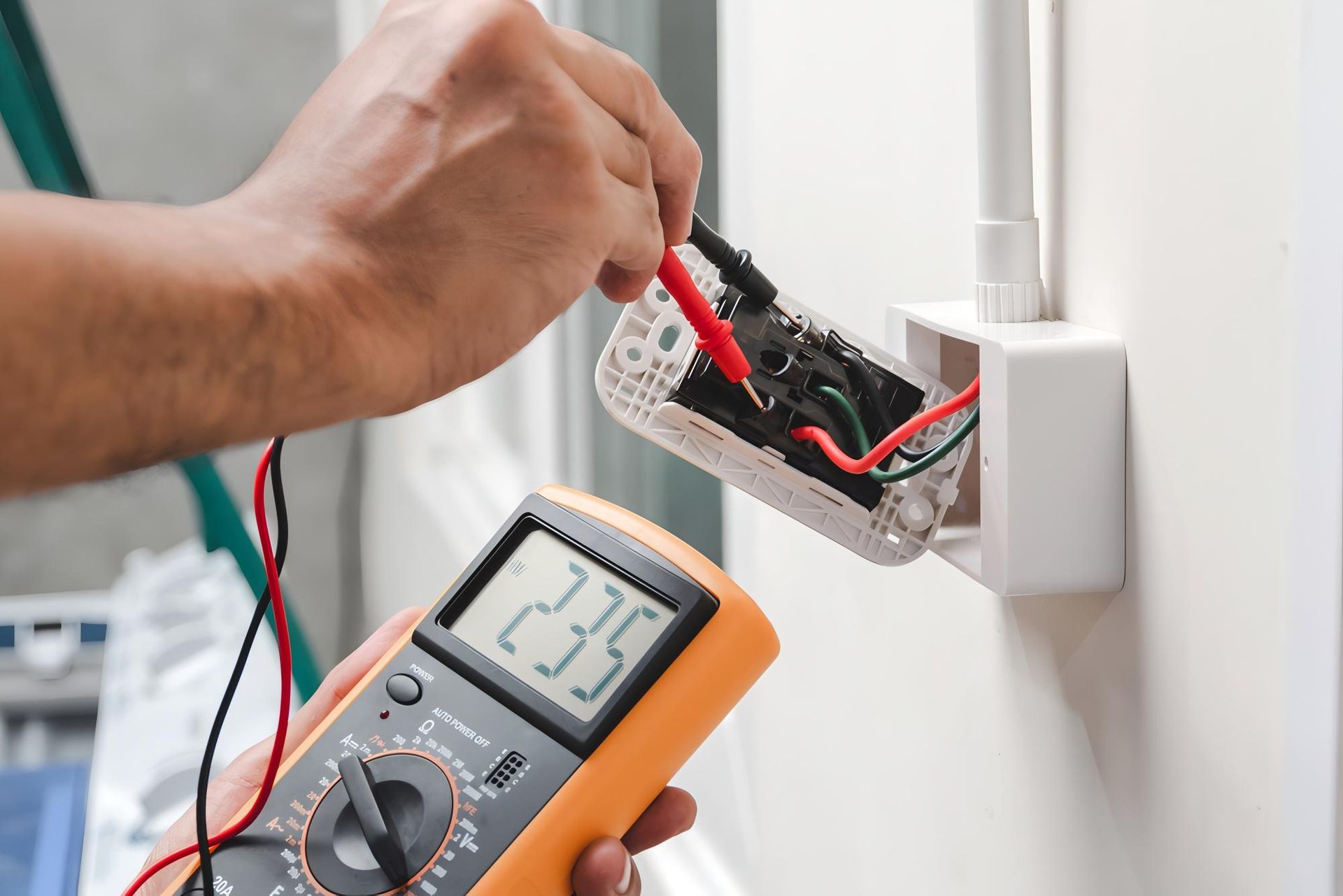 Electrician Uses a Multimeter to Test an Electrical Outlet — J&C Electrical Services in Walkerston, QLD
