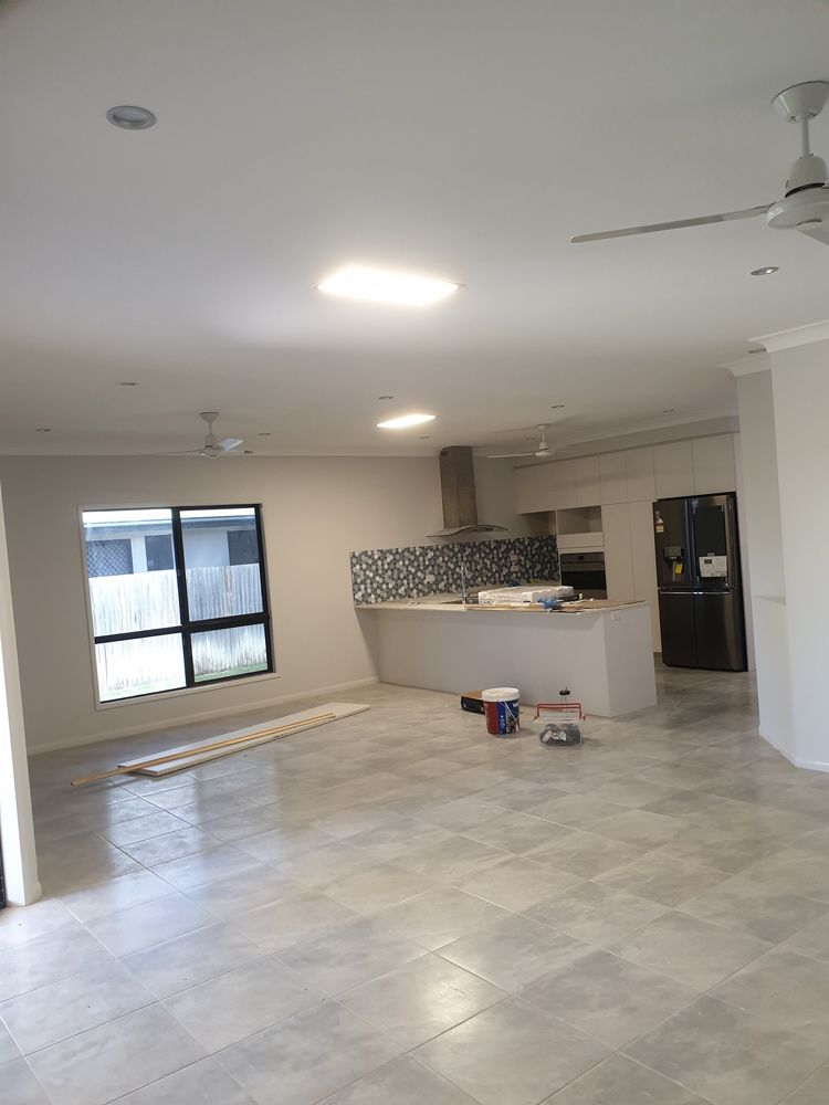 Empty Room With A Kitchen And On Going Painting Work — Insulation In Mount Louisa, QLD