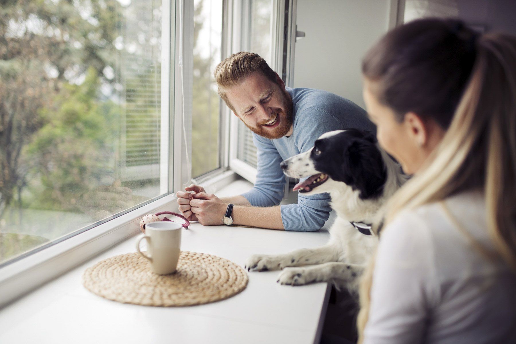 Beautiful couple relaxing at home and loving their pet