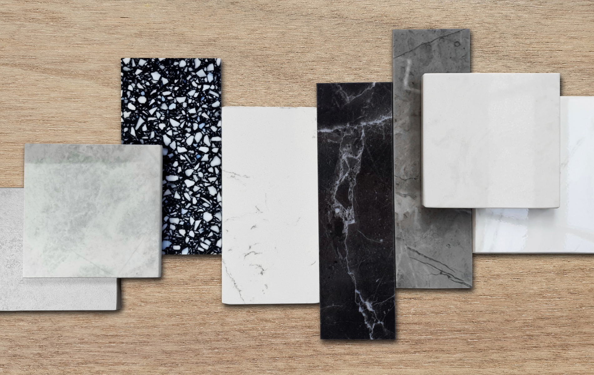 Samples of various stone and composite materials on a wood-grain background.