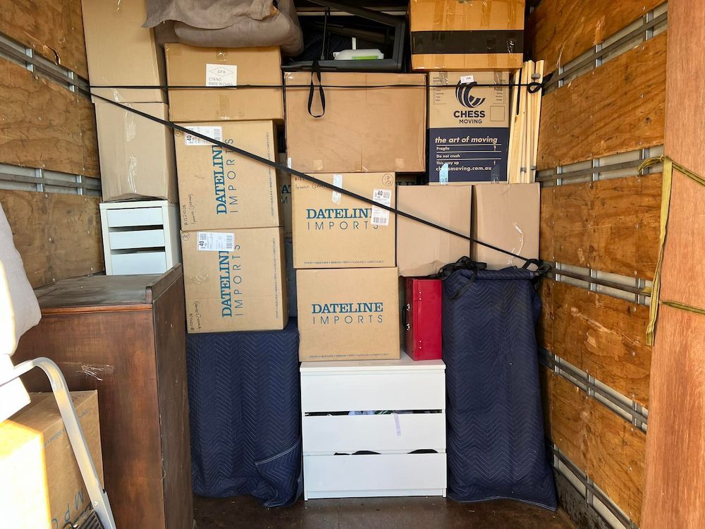 Boxes and Furniture Packed Inside a Moving Truck, Secured With Straps — Gantic Removals & Storage in Toowoomba, QLD