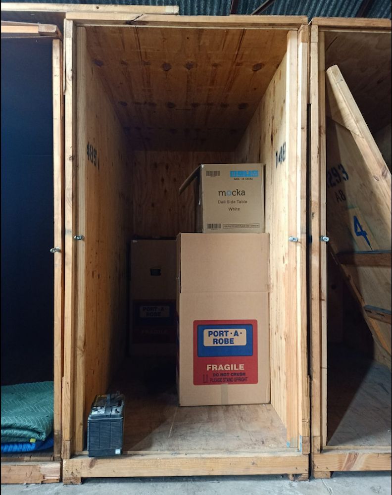 Wooden Storage Units Hold Boxes and a Small Radio — Gantic Removals & Storage in Logan, QLD