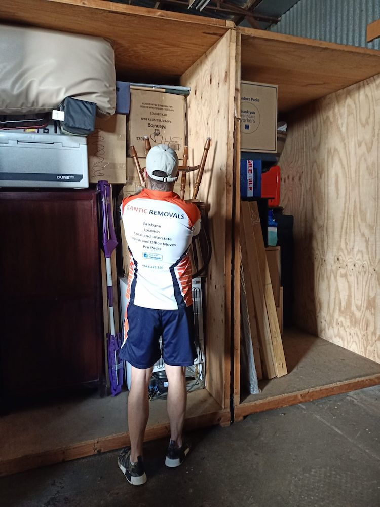 Man in a Storage Unit, Surrounded by Boxes and Items — Gantic Removals & Storage in Gold Coast, QLD