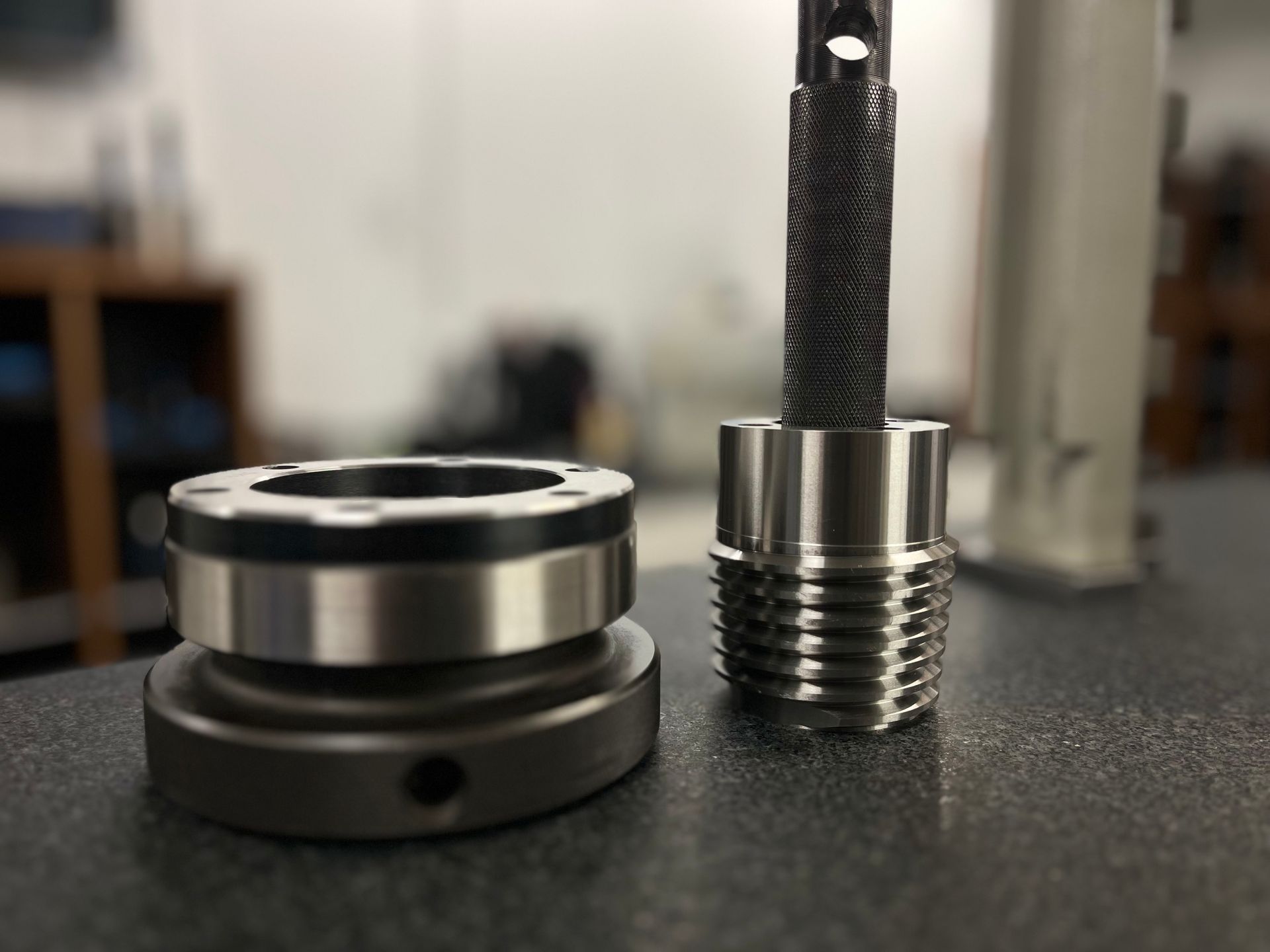 A person is measuring a piece of metal with a micrometer.