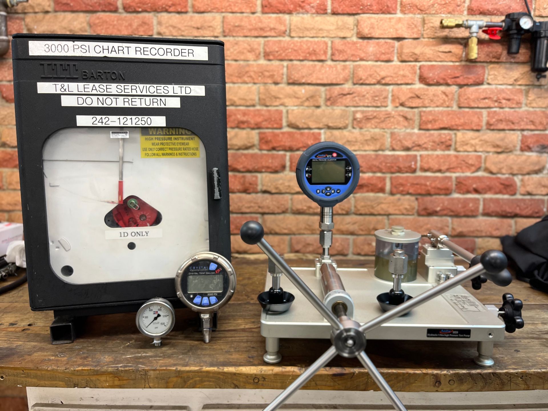 A group of pressure gauges are sitting on top of a table.