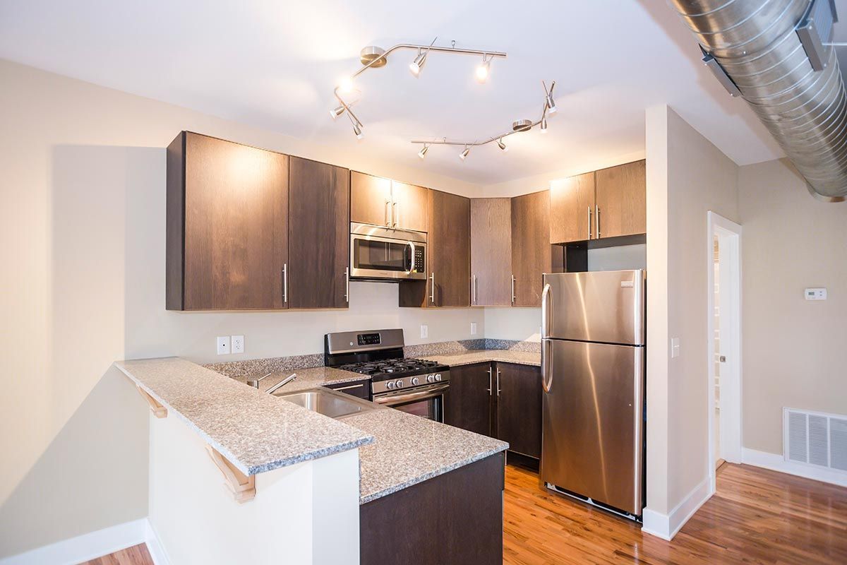 A kitchen with stainless steel appliances and granite counter tops