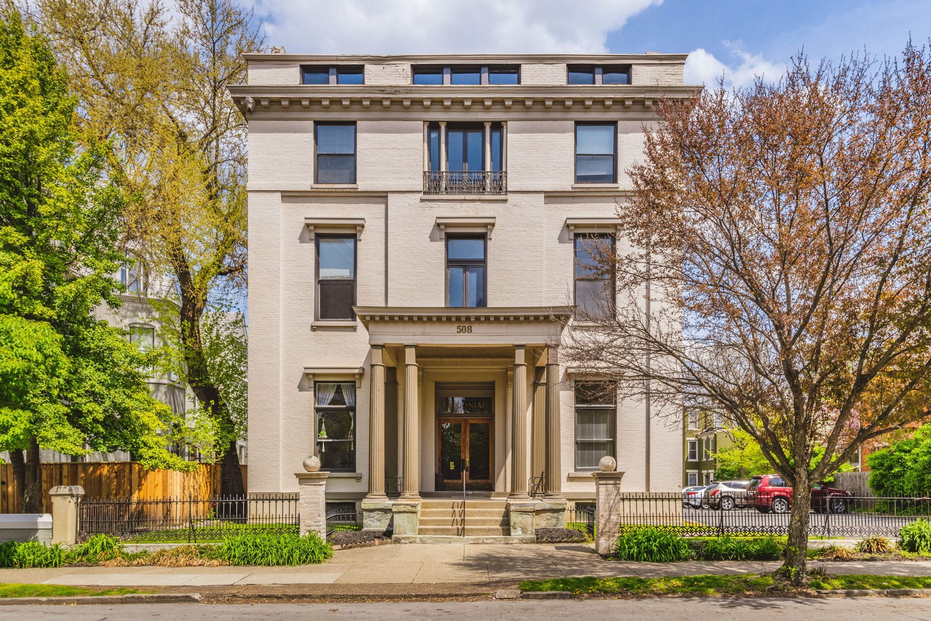 A large white building with trees in front of it