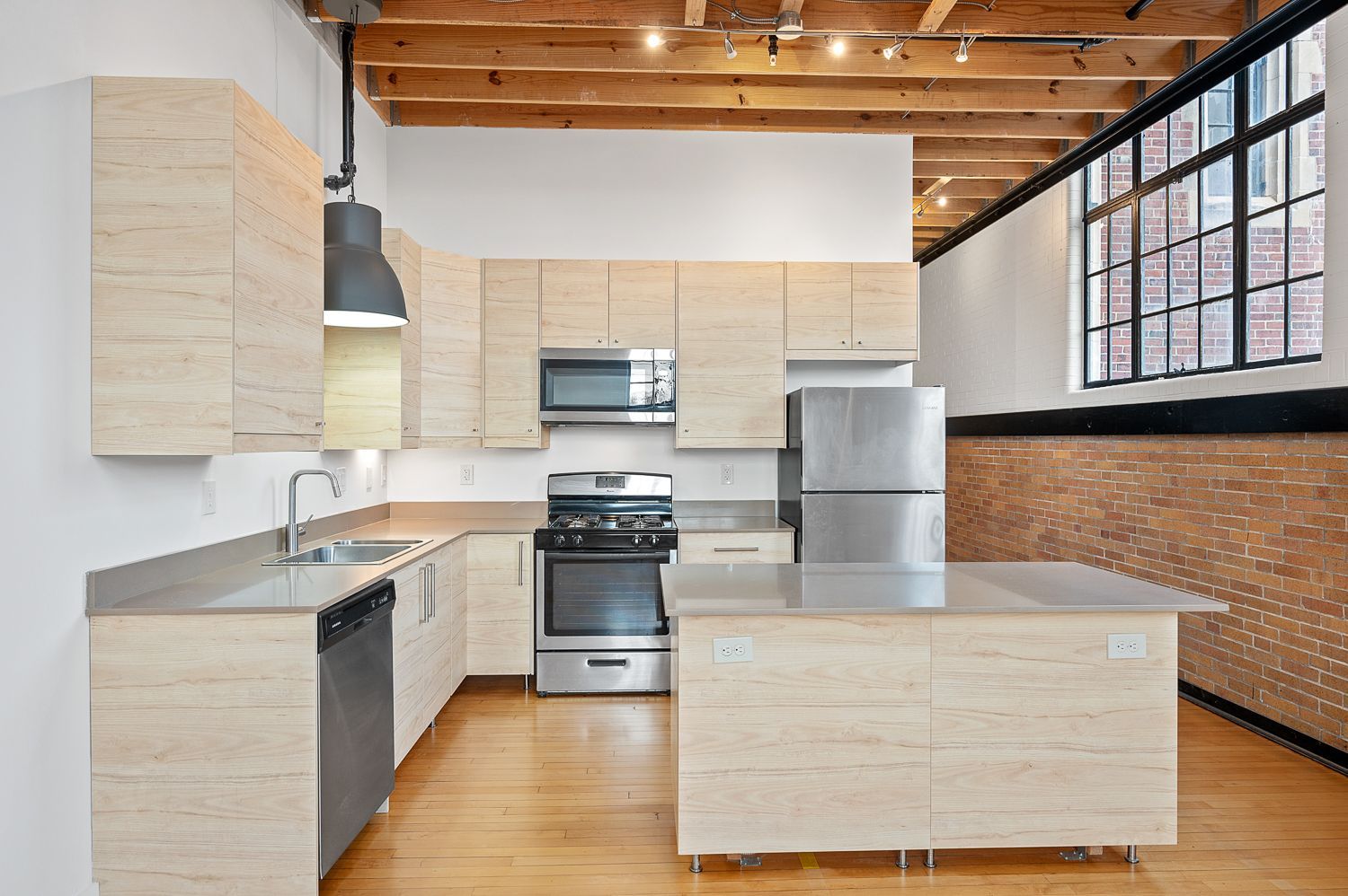A kitchen with stainless steel appliances and wooden cabinets