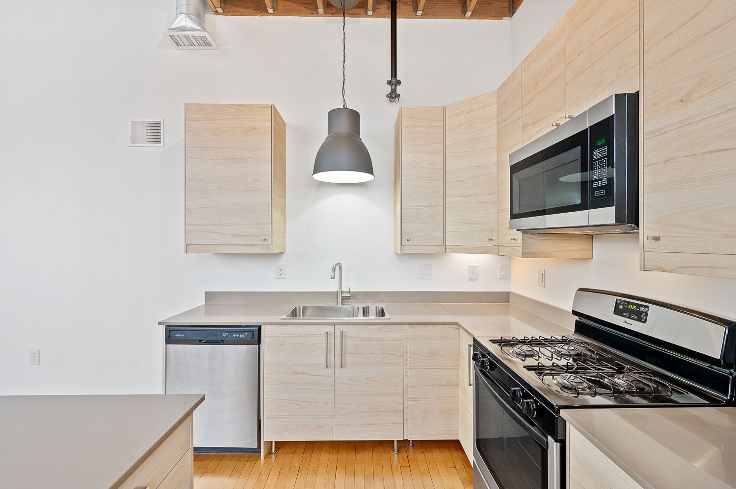 A kitchen with stainless steel appliances and wooden cabinets