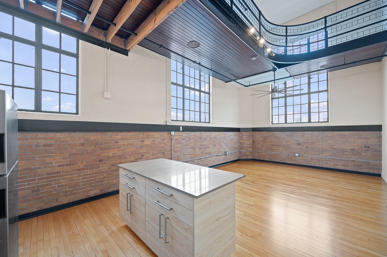 An empty kitchen with a large island in the middle