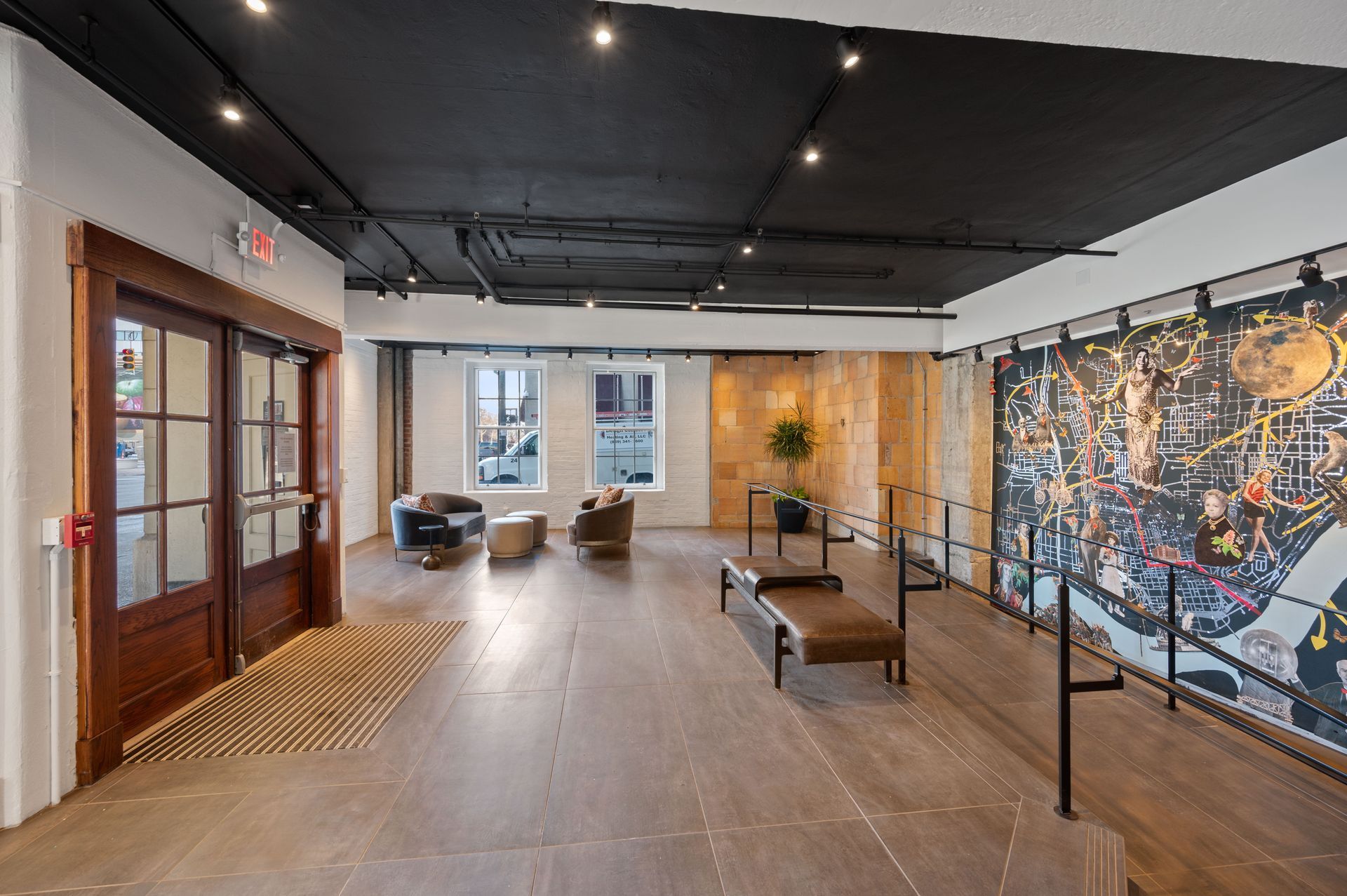 A large room with a lot of furniture and a mural on the wall.